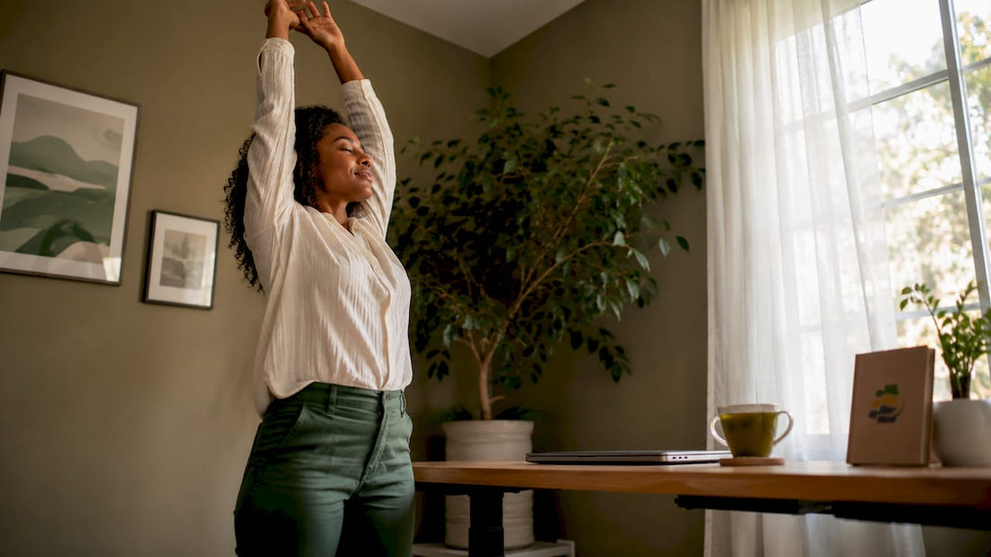 Woman stretching during standing break in office