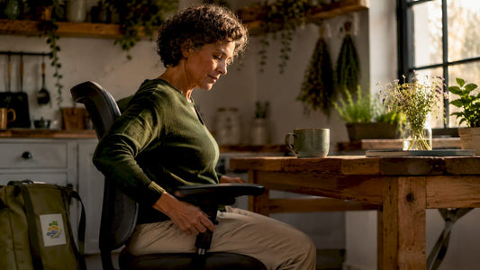 Woman adjusting chair armrest to improve posture