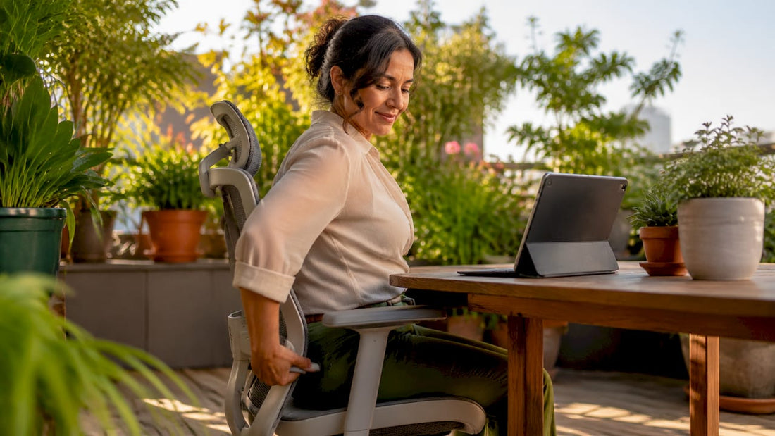 Woman adjusting ergonomic chair in open office