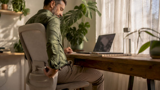 Man adjusting lumbar support on office chair