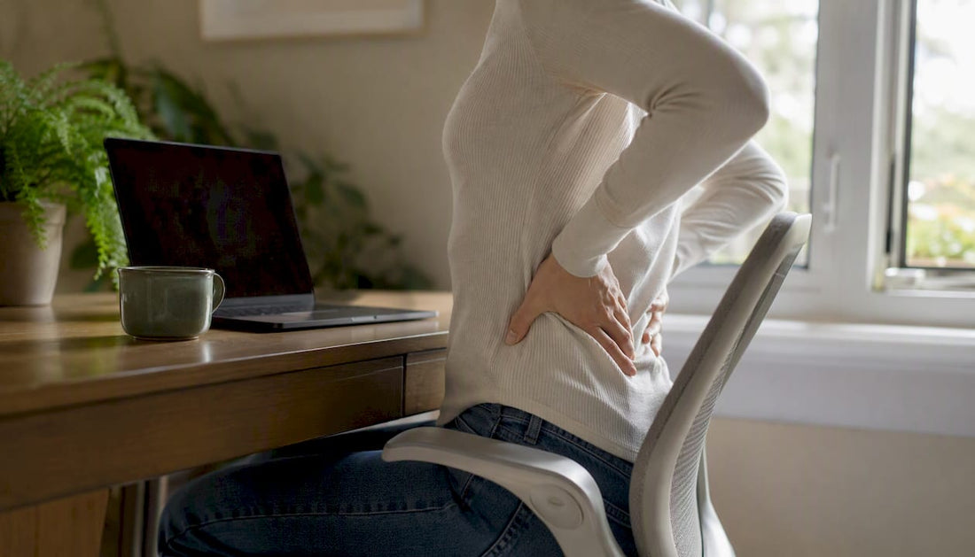 Hands adjusting seating posture at desk